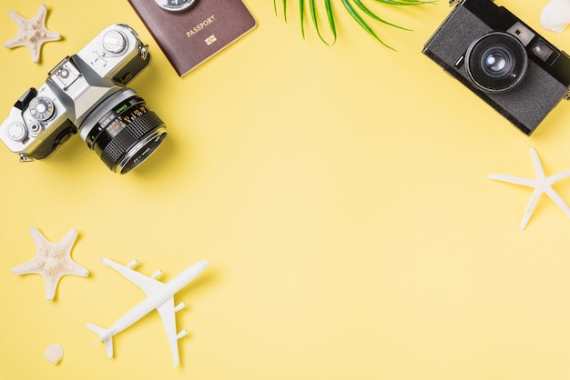 Photo flat lay mockup retro camera films airplane leaves starfish traveler tropical beach accessories