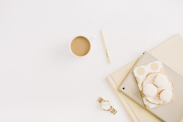 Flat lay modern concept with macaroons, coffee mug, feminine stuff on white