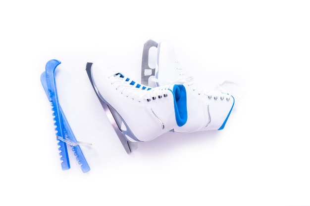 Flat lay. New white figure skates on a white background.