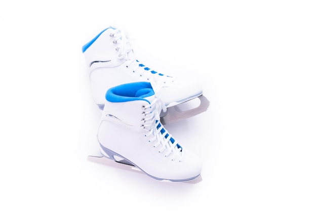 Flat lay. New white figure skates on a white background.