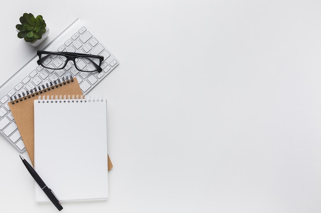 Flat lay of notebooks and glasses on desktop