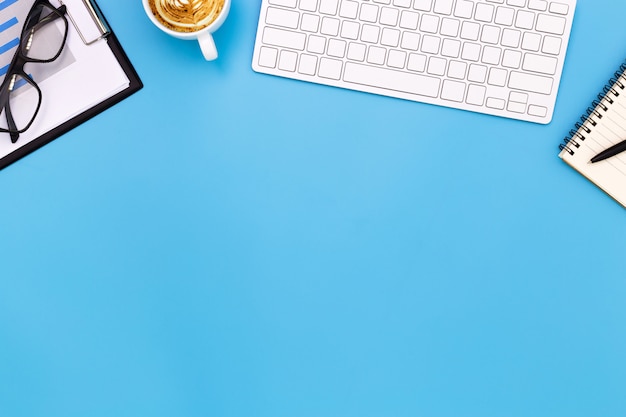 flat lay Office desk table of modern workplace with laptop on blue table, top view laptop background and copy space on black background, blue desk office with laptop,