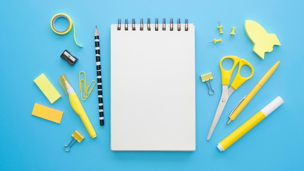 flat lay of office stationery with notebook and scissors