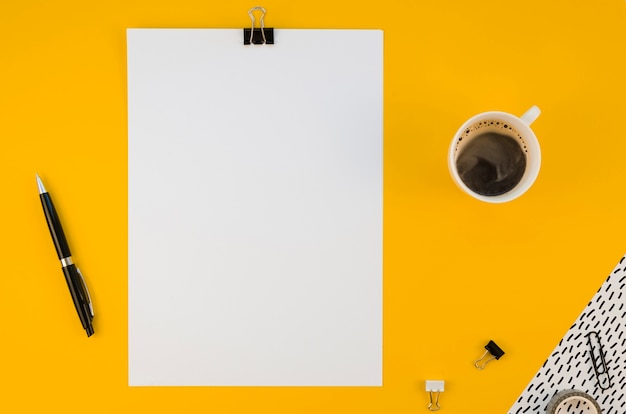 Flat lay of office supplies with coffee