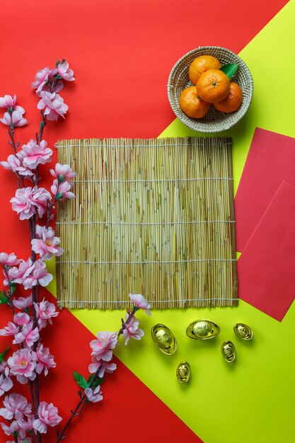 Flat lay orange & dessert also red pocket money on  wooden at home desk.