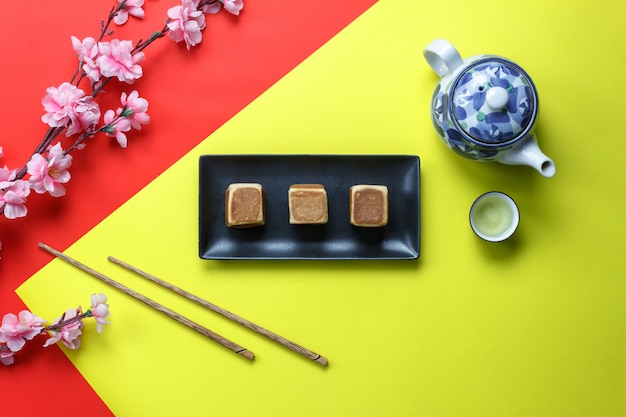 Flat lay orange & dessert also red pocket money on  wooden at home desk.