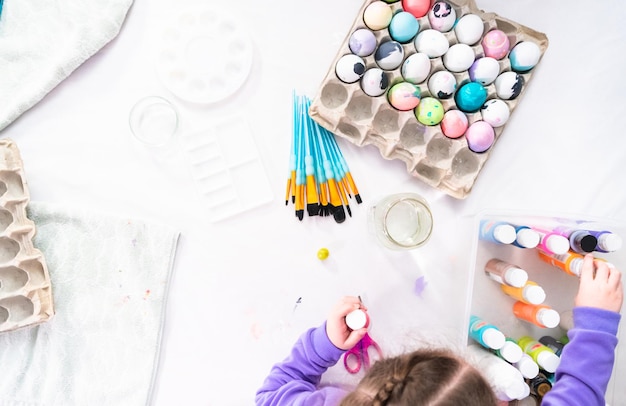 Flat lay. Painting craft Easter eggs with arcylic paint.