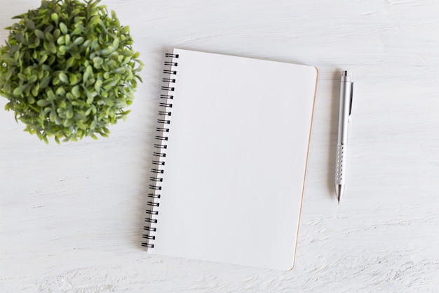 Flat lay photo of office desk on white background