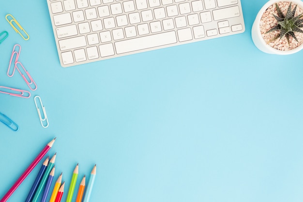 Flat lay photo of office desk with pencil and keyboard