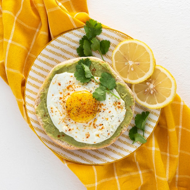 Flat lay pita with avocado spread and fried egg on plate