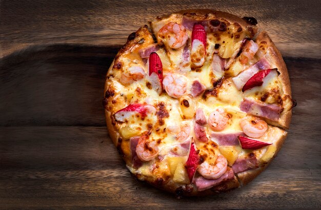 Flat lay Pizza pepperoni, mozzarella, oregano on a wood background