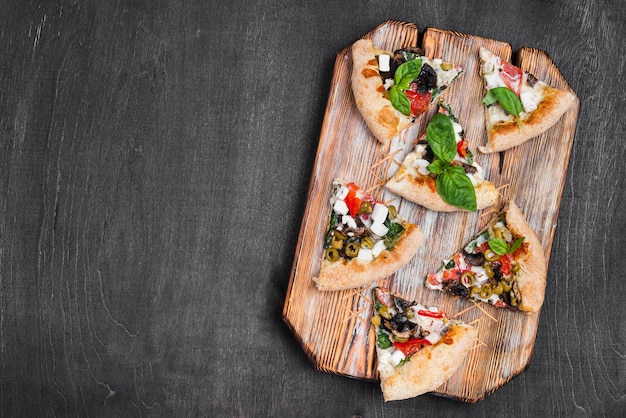 Flat lay pizza slices on cutting board