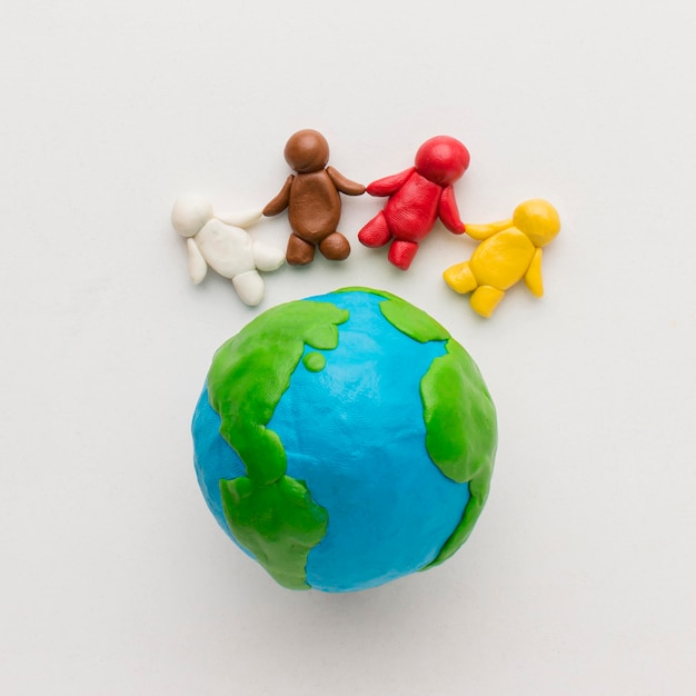 Flat lay of plasticine globe and people