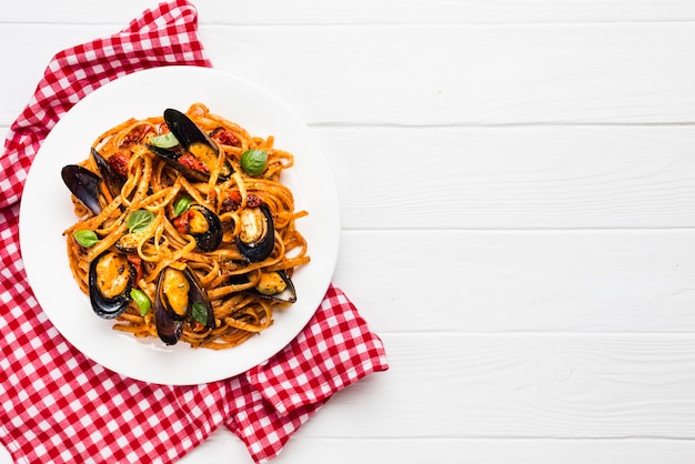 Flat-lay plate of mussels pasta with copyspace