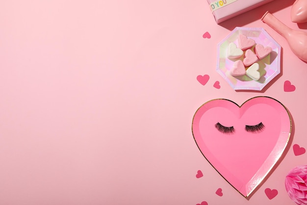 Photo flat lay plate in the shape of a heart on a pink background