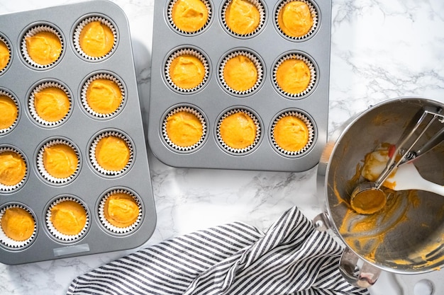 Flat lay. pumpkin spice cupcake batter in a cupcake pan with liners