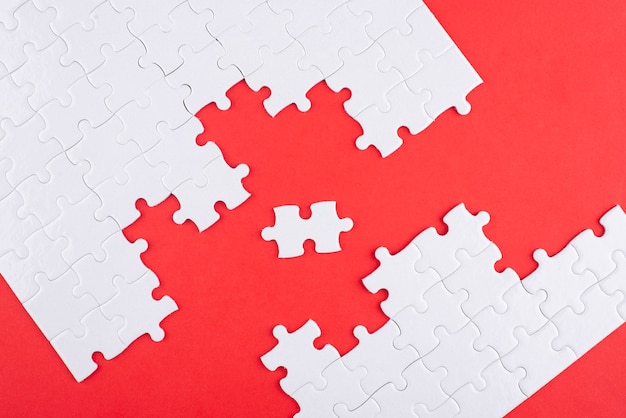 Flat lay puzzle pieces and red background