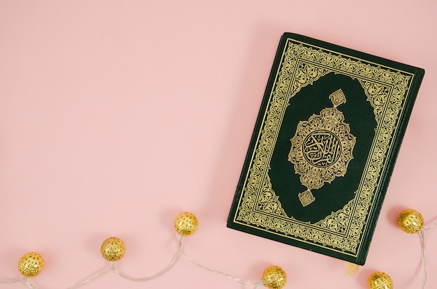 Flat lay quran on a light pink background