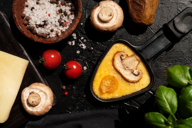 Flat lay of raclette dish with ingredients and delicious food