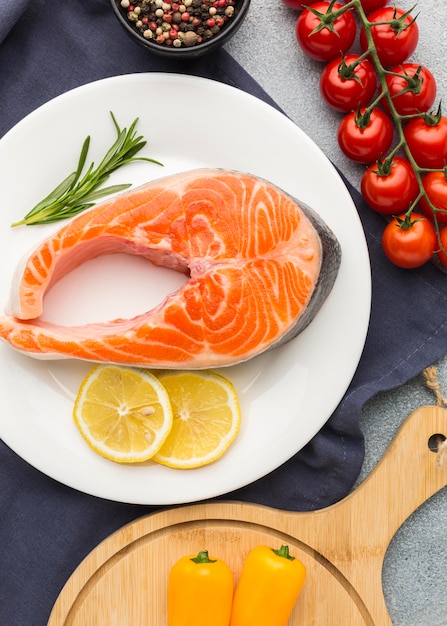 Flat lay salmon and lemon on plate