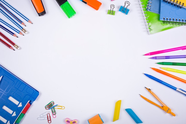 flat lay of school supplies on a minimalist blue space. School supplies with copy space