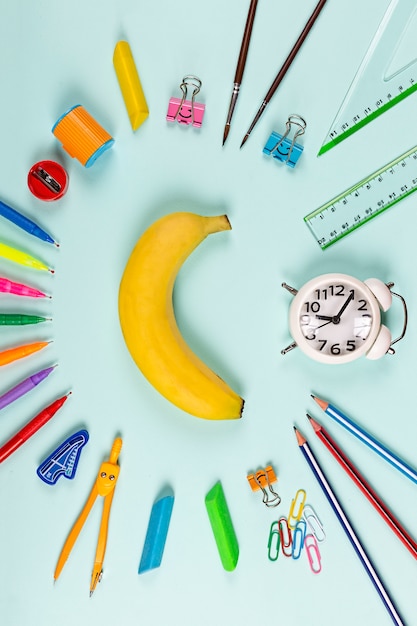 flat lay of school supplies on a minimalist blue space