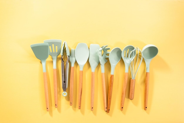 Flat lay. Silicone cooking utensils with wooden handle.