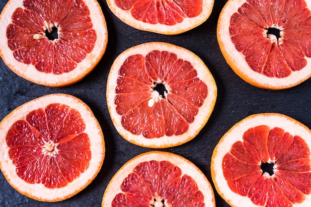 Flat lay slices of raw fresh red orange fruit.