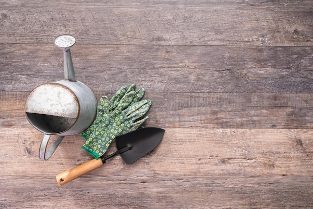 Flat lay. Small garden tools are ready for Spring planting season. Included garden gloves, shovel, watering can and plant tags.