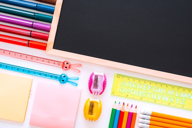 Flat-lay stationery chalk board on white of the table