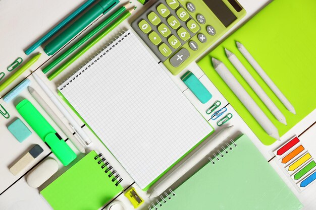 Flat lay of stationery on white wooden table background copy space