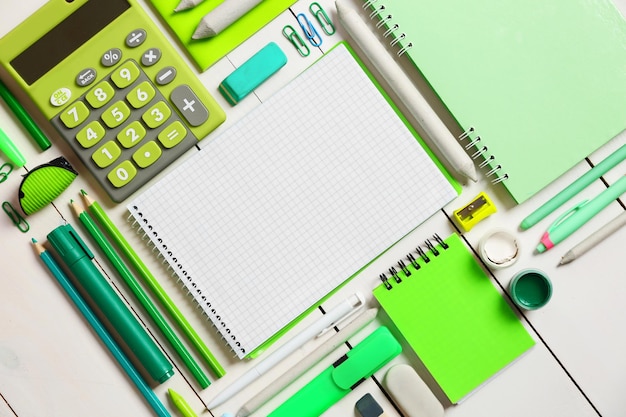 Flat lay of stationery on white wooden table background copy space