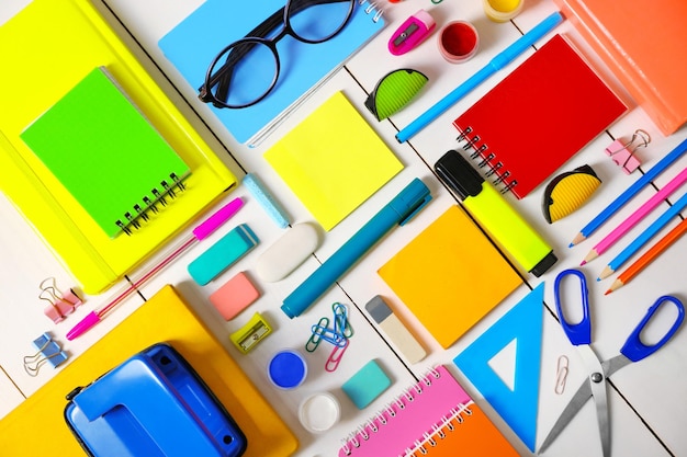 Flat lay of stationery on white wooden table background