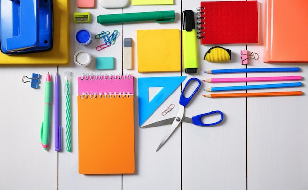 Photo flat lay of stationery on white wooden table background