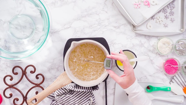 Flat lay. Step by step. Caramelizing sugar in a small cooking pot over the small electric stove.