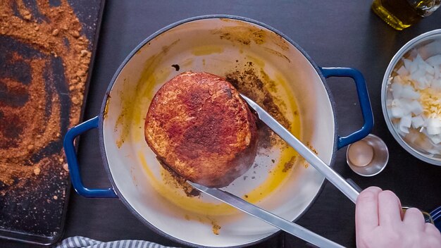 Flat lay. Step by step. Cooking boneless pork roast in cast iron dutch oven.