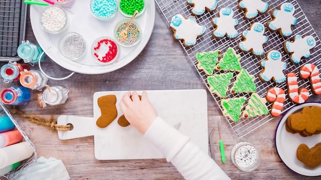 Flat lay. Step by step. Decorating gingerbread and sugar cookies with royal icing for Christmas.