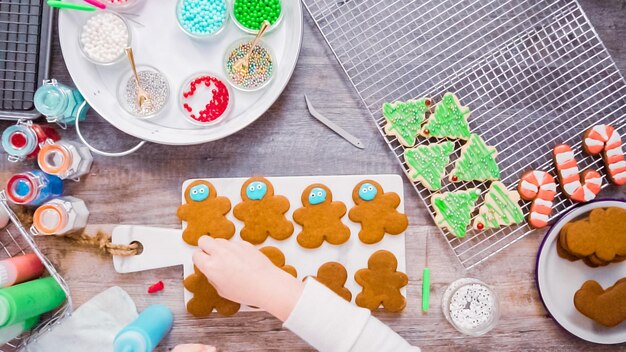 Flat lay. Step by step. Decorating gingerbread and sugar cookies with royal icing for Christmas.