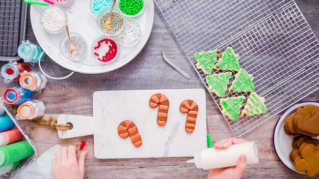 Flat lay. Step by step. Decorating gingerbread and sugar cookies with royal icing for Christmas.