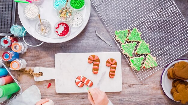 Flat lay. Step by step. Decorating gingerbread and sugar cookies with royal icing for Christmas.