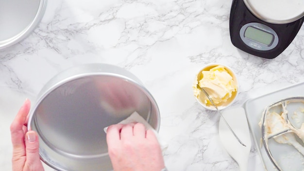 Flat lay. Step by step. Greasing cake pans with butter to bake funfetti cake.