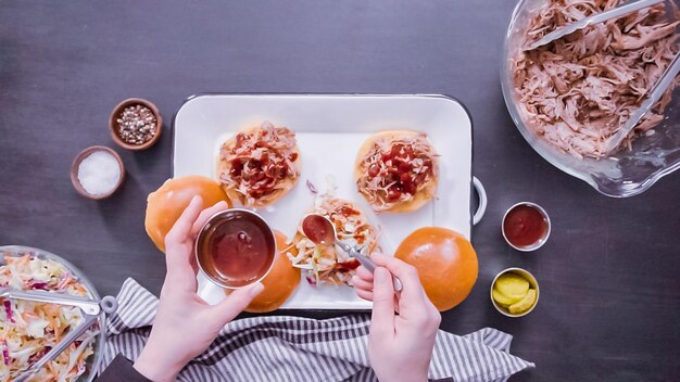 Flat lay. Step by step. Making pulled pork sandwiches with coleslaw on brioche buns.