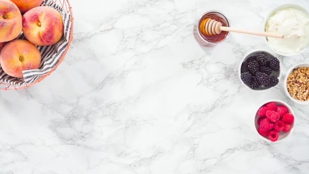 Flat lay. Step by step. Making ricotta toasts with organic peaches and berries.