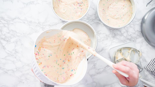 Flat lay. Step by step. Measuring funfetti cake batter on a digital kitchen scale.