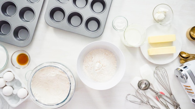 Photo flat lay. step by step. mixing batter to bake vanilla cupcakes with buttercream frosting.