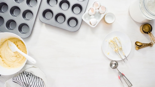 Photo flat lay. step by step. mixing batter to bake vanilla cupcakes with buttercream frosting.