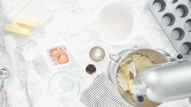 Flat lay. Step by step. Mixing ingredients in kitchen mixer to bake mermaid theme vanilla cupcakes.