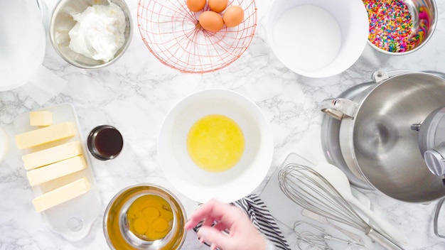 Flat lay. Step by step. Mixing ingredients in standing kitchen mixer to make funfetti cake.