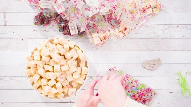 Flat lay. Step by step. Packaging homemade candy cane fudge into small gift bags.