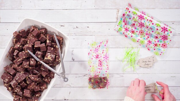 Flat lay. Step by step. Packaging homemade macadamia fudge into small gift bags.